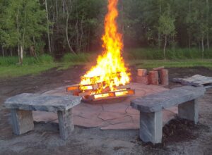 Two assembled benches around a firepit.